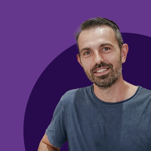 man in front of purple circle